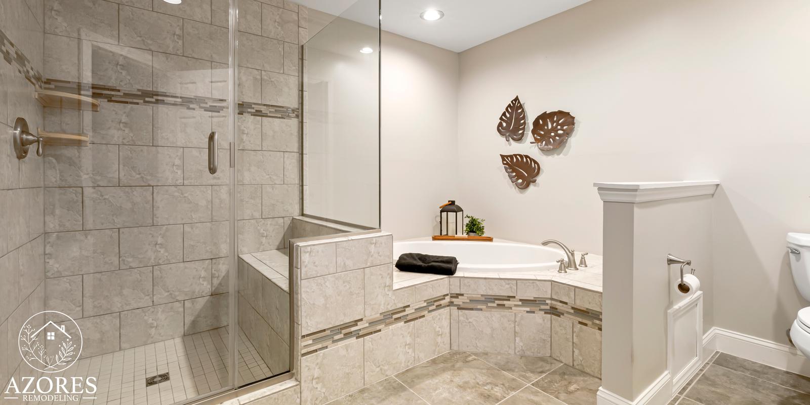 Custom herringbone tile shower with gold fixtures and built-in niche